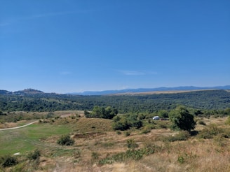 A panoramic view of Kangaroo Valley with a Bluepeak Digital vehicle parked at a lookout, capturing the lush green landscape.