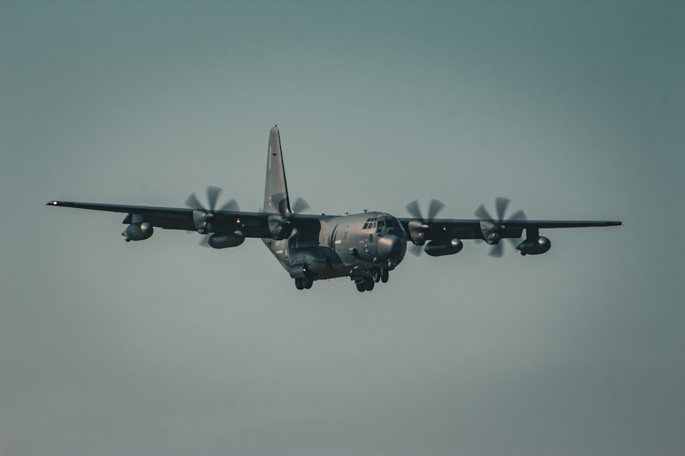 a large air plane flying through a cloudy sky