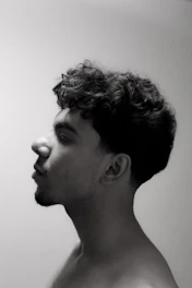 Portrait of Cyril Chameau with soft rounded edges, set against a warm cream background.