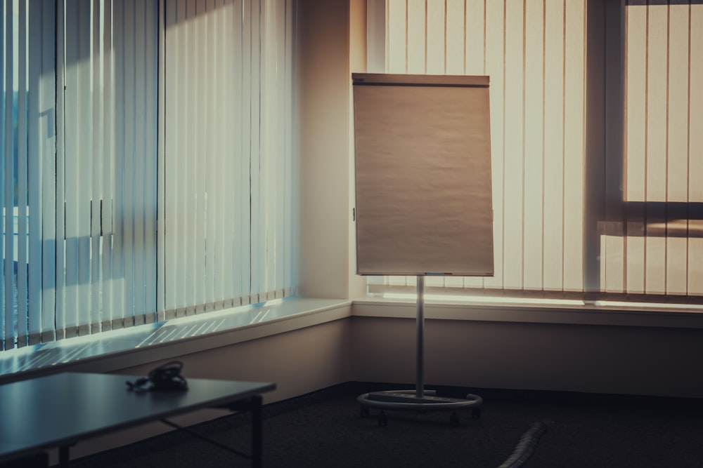 a room with a window and a sign in the corner