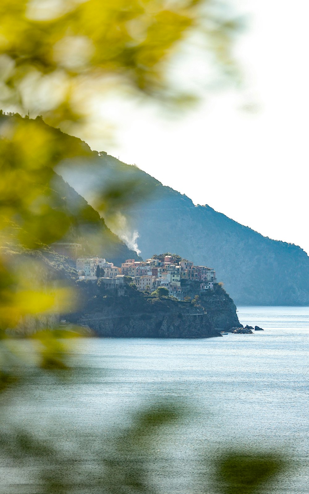 a view of a town on a hill near the ocean