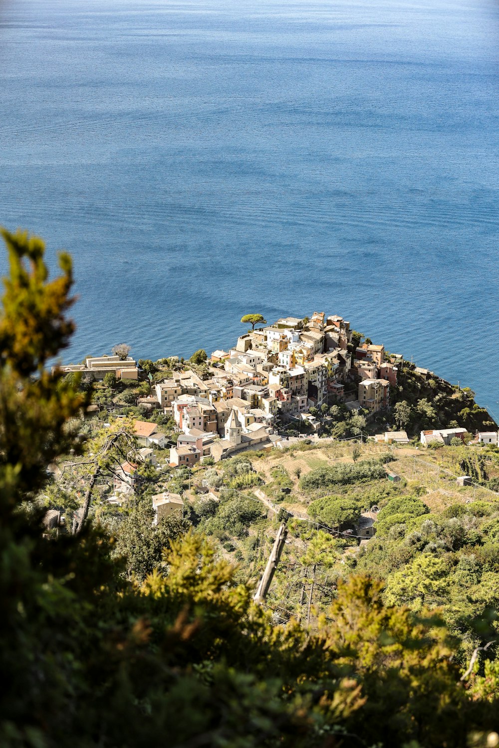 a small village on top of a hill near the ocean