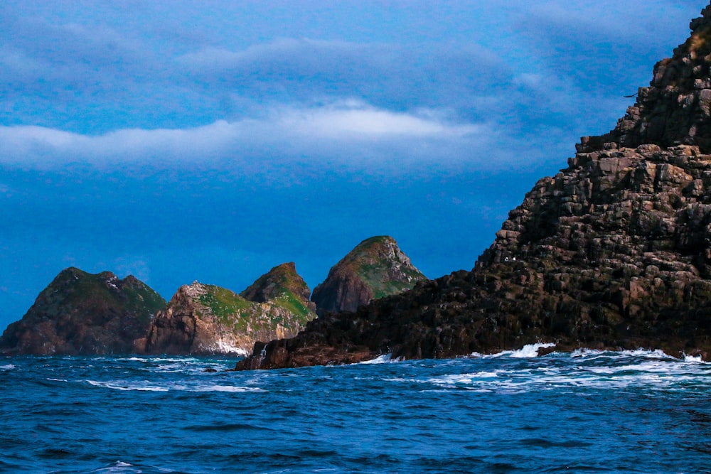 a large body of water next to a rocky shore