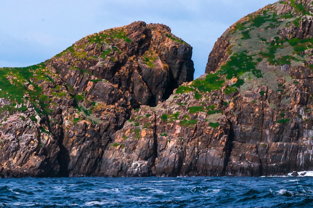 a large rock outcropping in the middle of the ocean