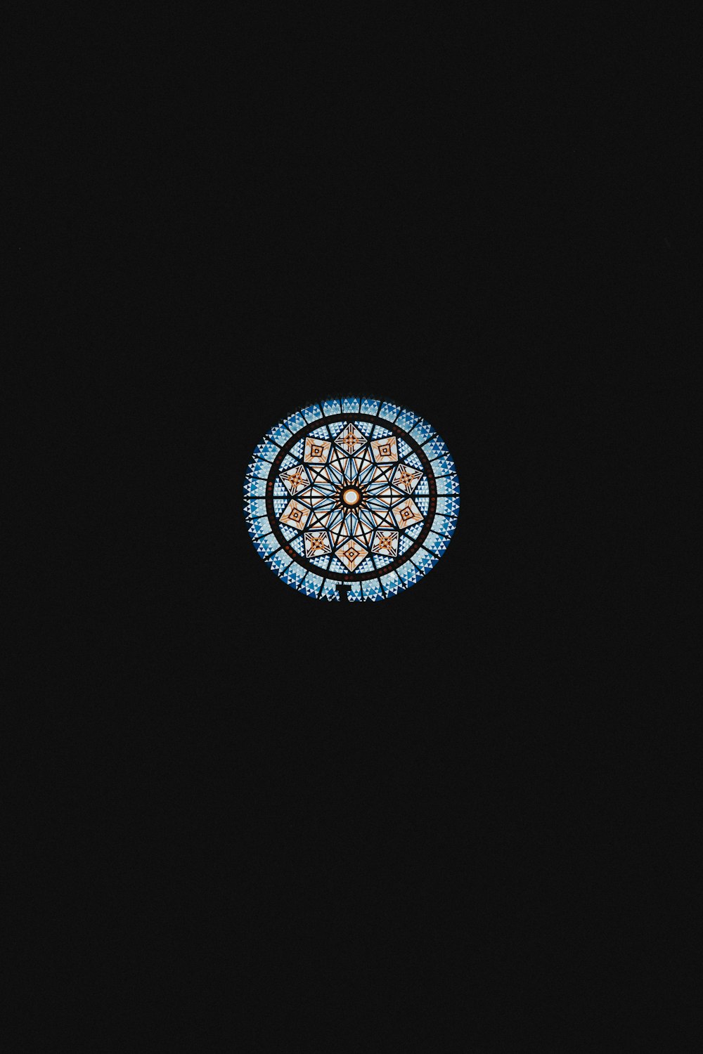 a window with a circular design in the middle of it