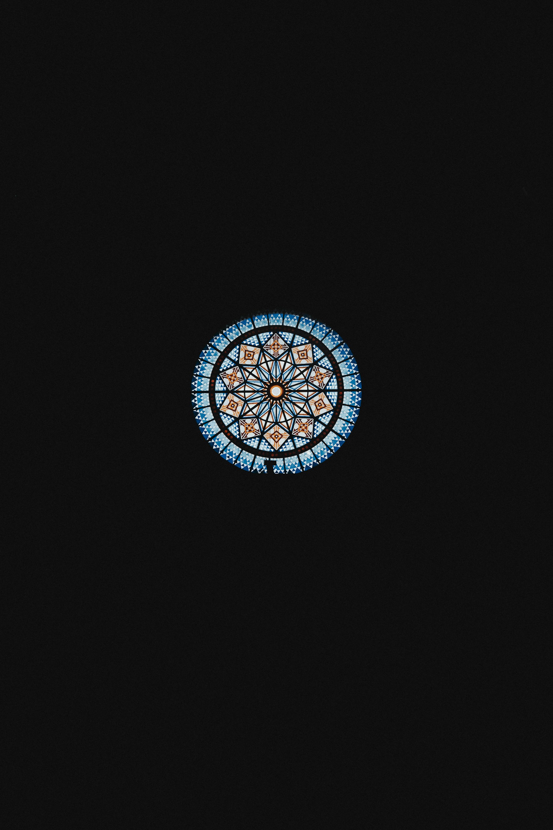 a window with a circular design in the middle of it