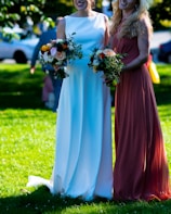 a couple of women standing next to each other on a lush green field