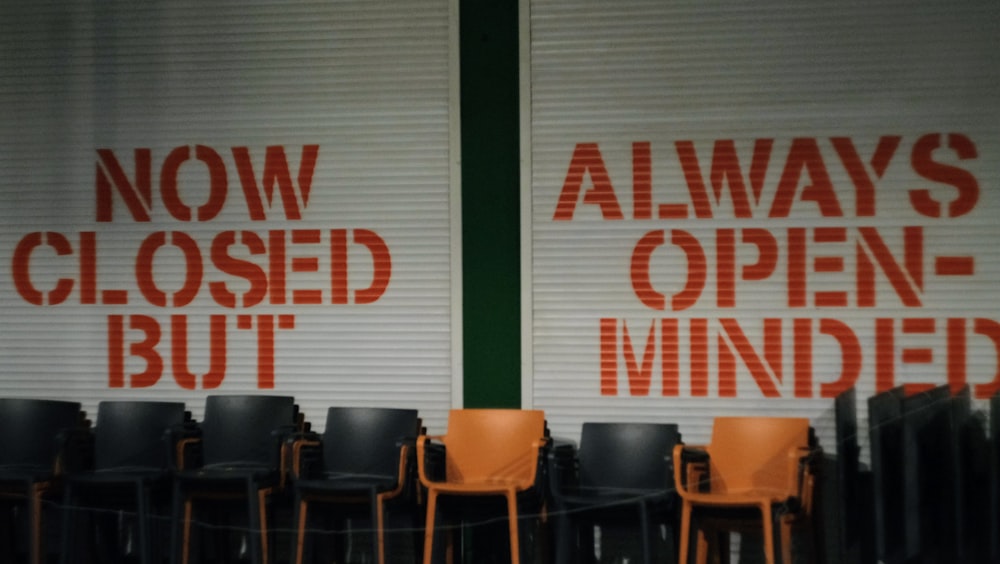 a row of chairs sitting in front of a closed window