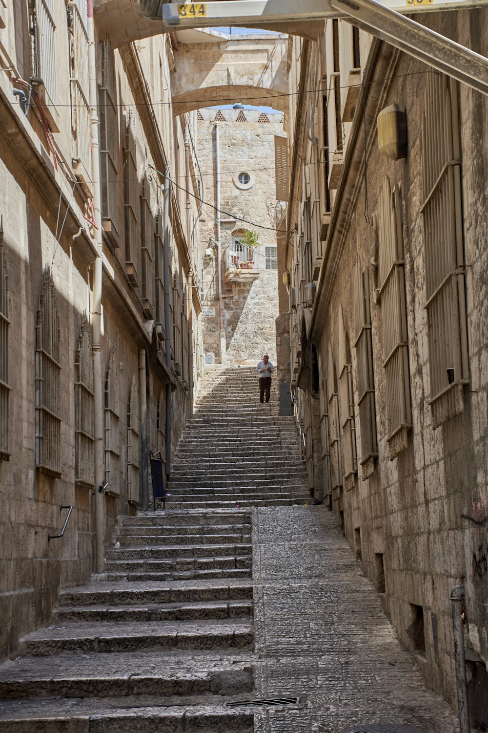 a man walking down a set of stone stairs