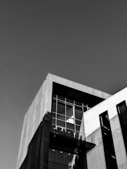 A 3D architectural rendering showcasing a modern building with sharp lines and shadows