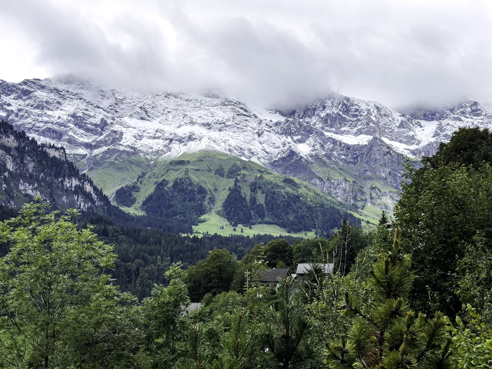 a view of a snowy mountain range with a house in the foreground