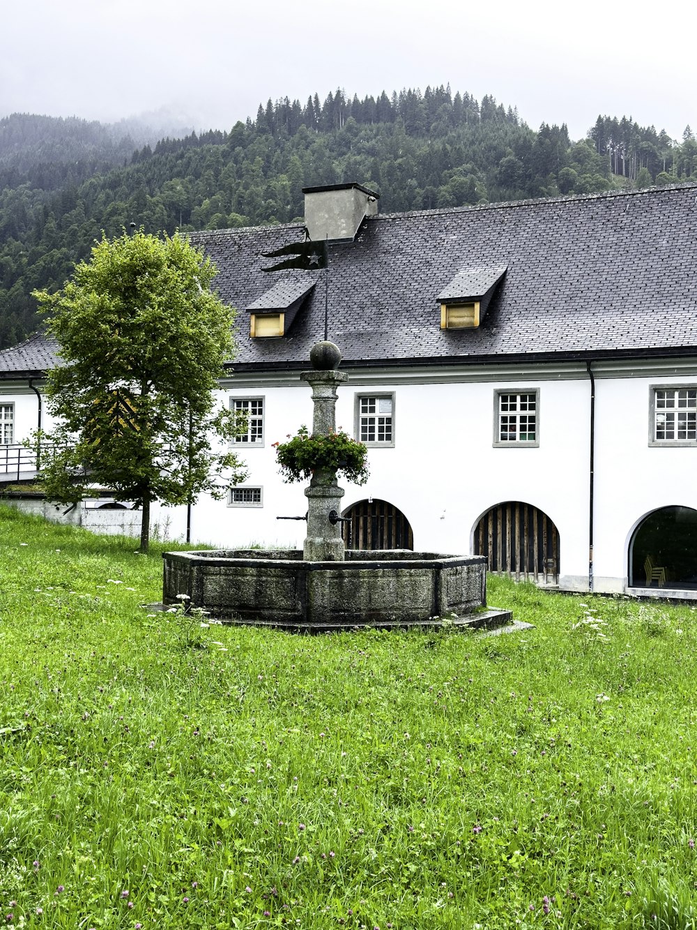 a white building with a fountain in front of it