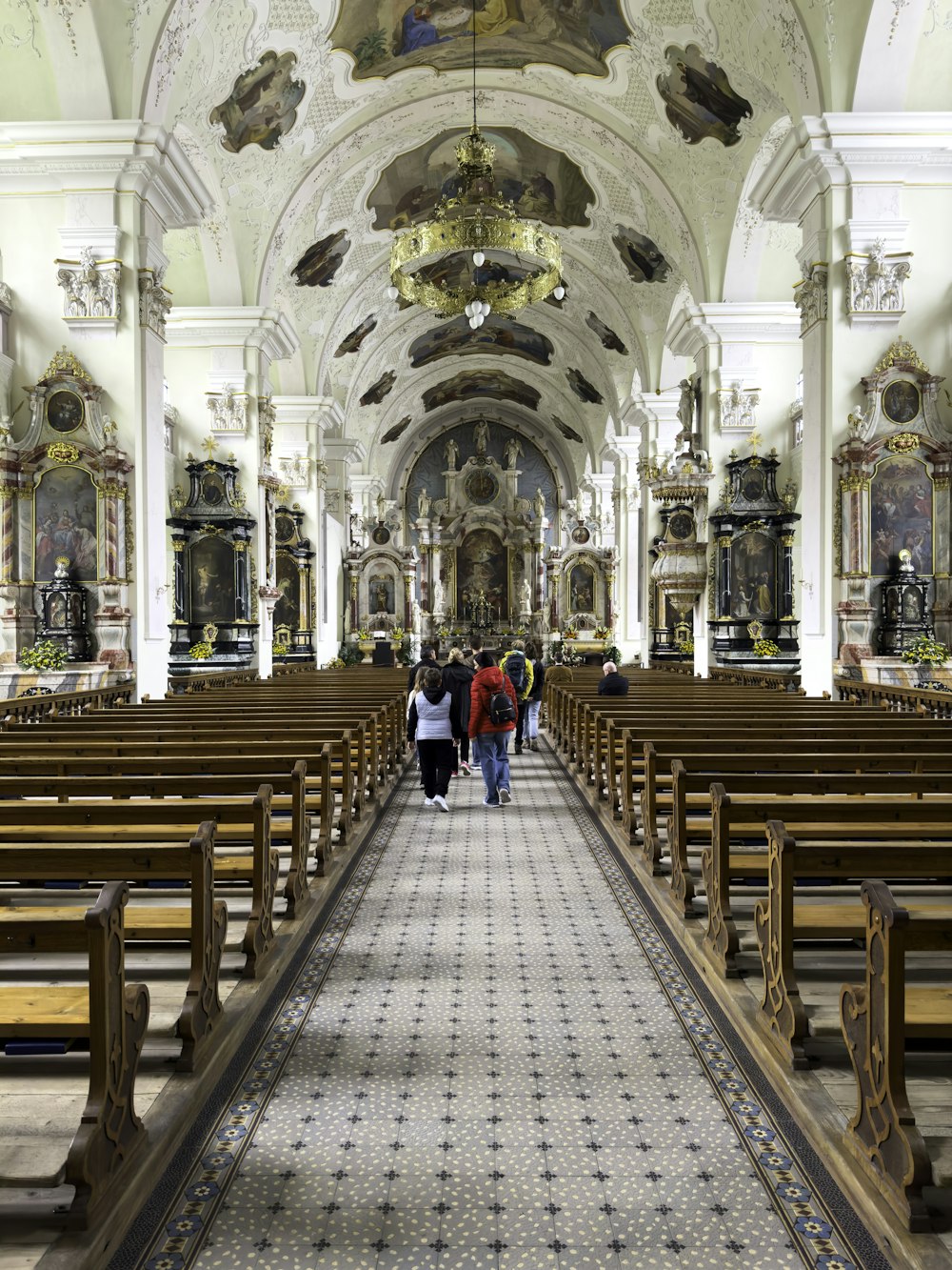 a group of people walking down a church aisle
