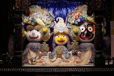 Close-up of intricate papel maché figures painted with bright colors and fine details.