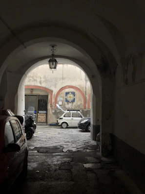 Exterior view of Voltara’s shop in Leerbatch Palace, Arjan, with cars parked outside.