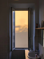 Sunlight filtering through large windows onto a beautifully finished bathroom renovation.