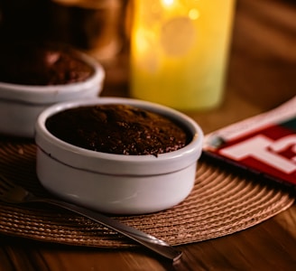 A festive table setting featuring Malaku LLC chocolate boxes surrounded by soft candlelight