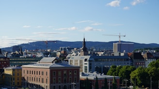 A skilled civil engineer reviewing detailed blueprints with a modern city skyline in the background.