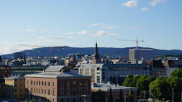 Engineers discussing project plans with a city skyline in the background.