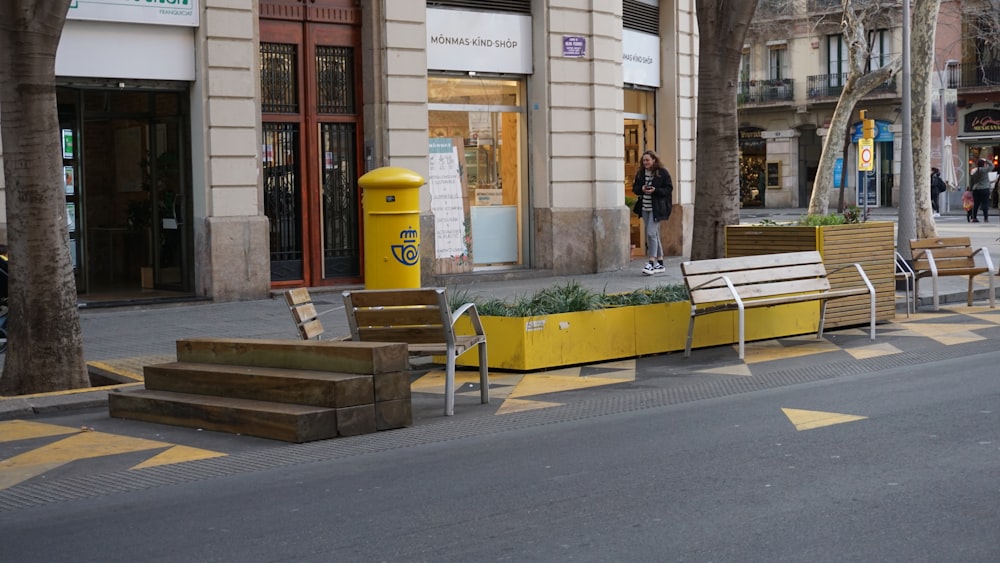 a row of benches sitting on the side of a street