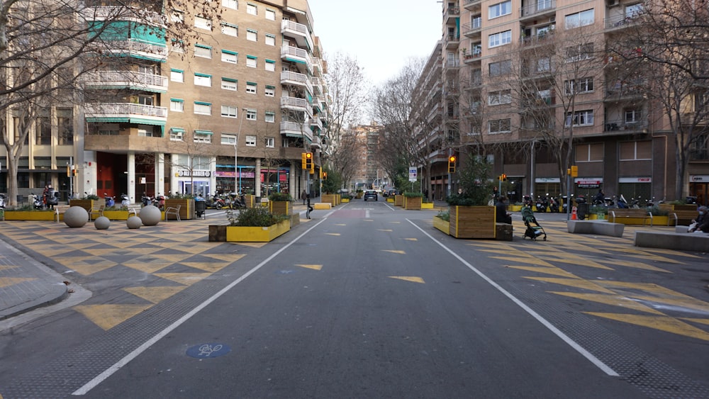 a city street with buildings and people walking on the sidewalks