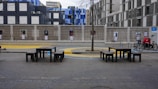 Urban stainless steel benches and fixtures in a public park.