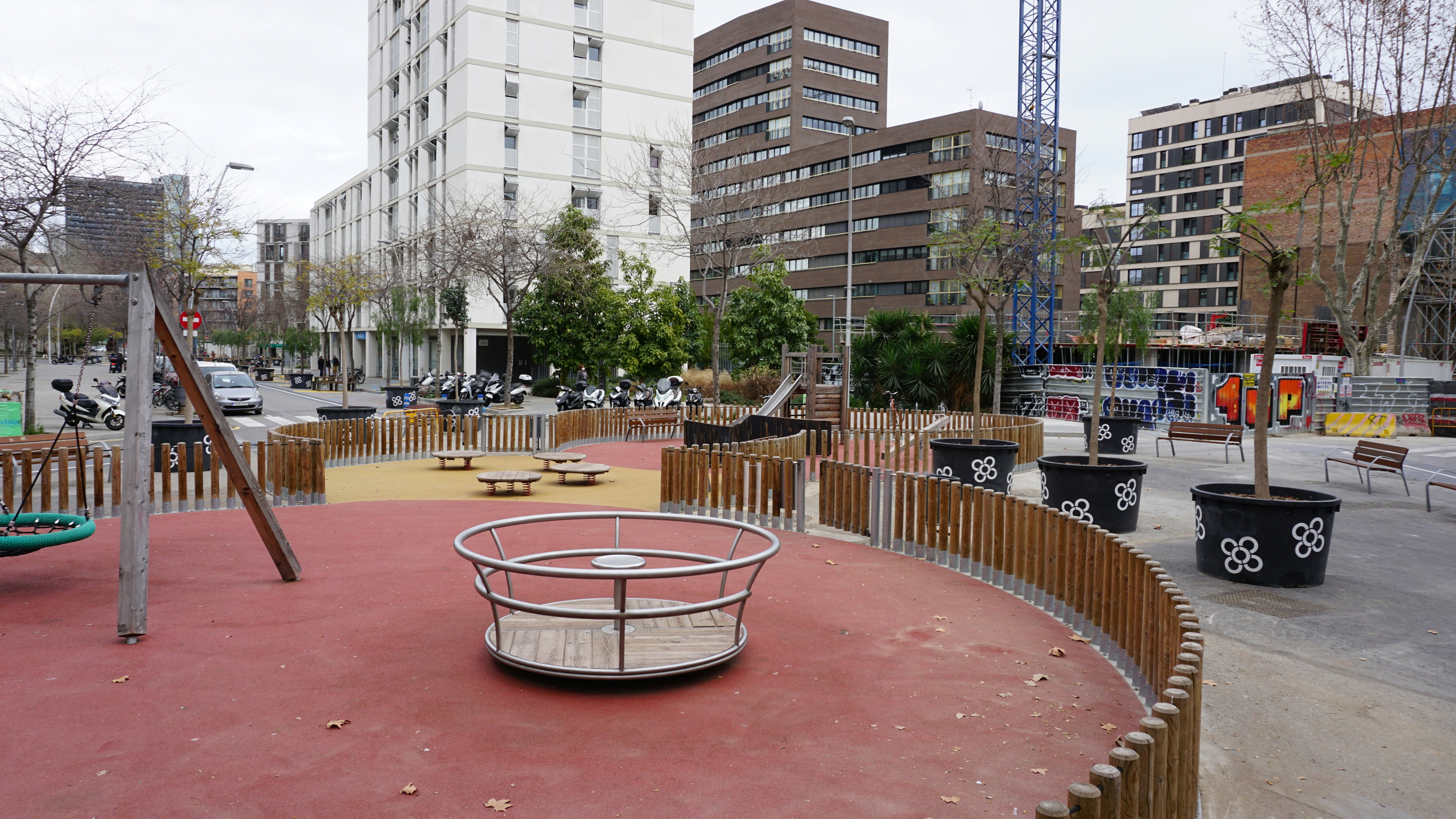 a playground in a city with lots of buildings in the background