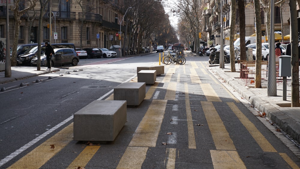 a city street lined with tall buildings and parked bikes