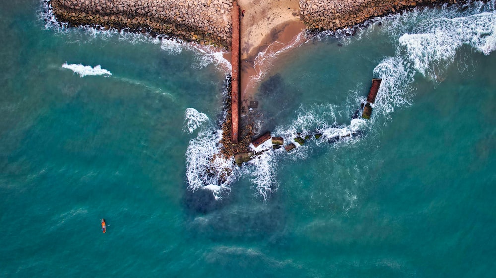 an aerial view of a beach and a pier