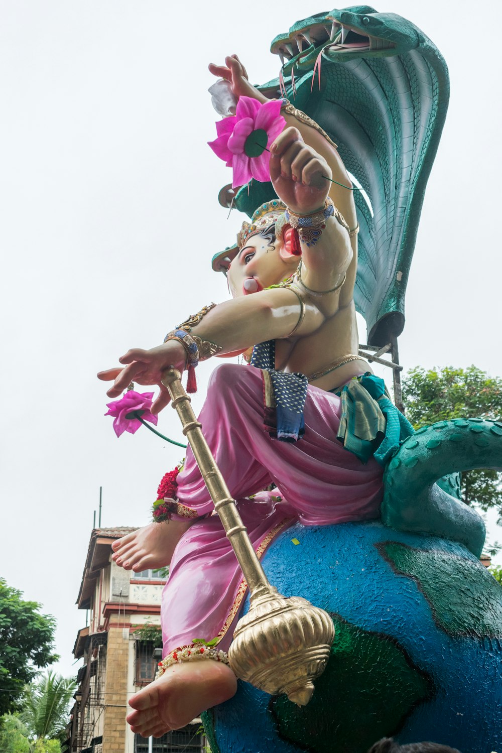 a statue of a man riding on the back of a blue elephant