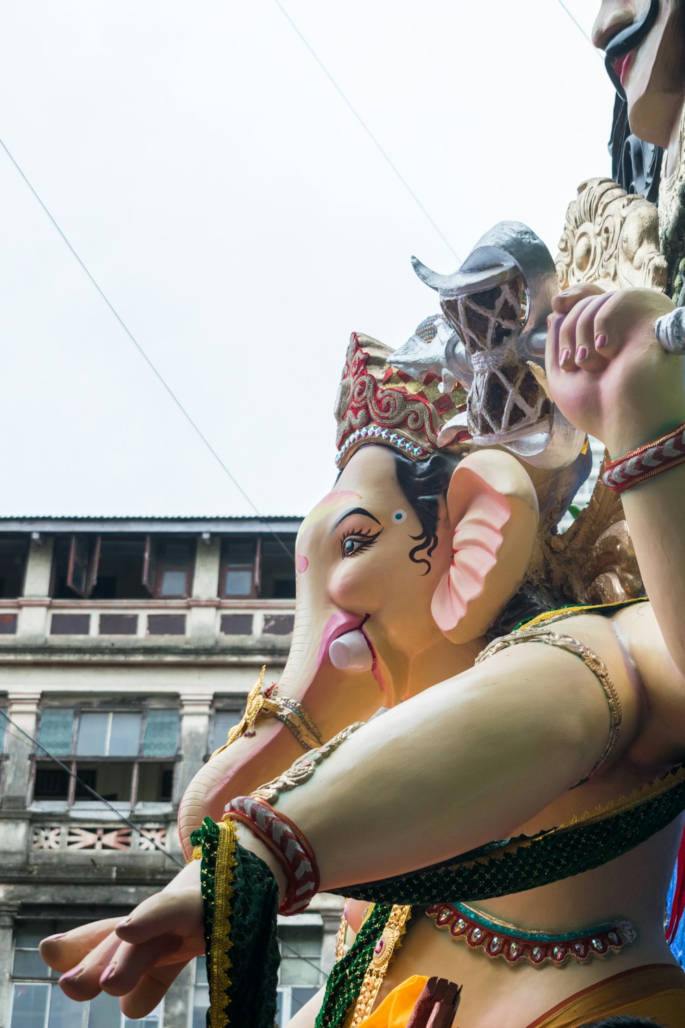 a statue of an elephant with a woman on its back