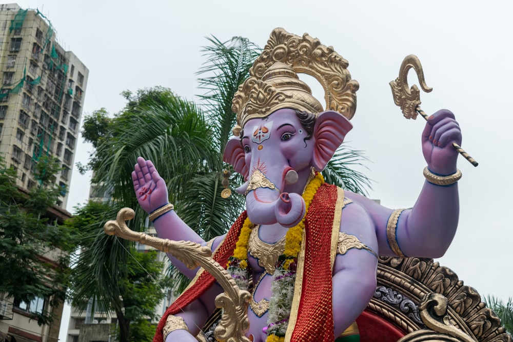 a statue of an elephant with a pipe in its mouth