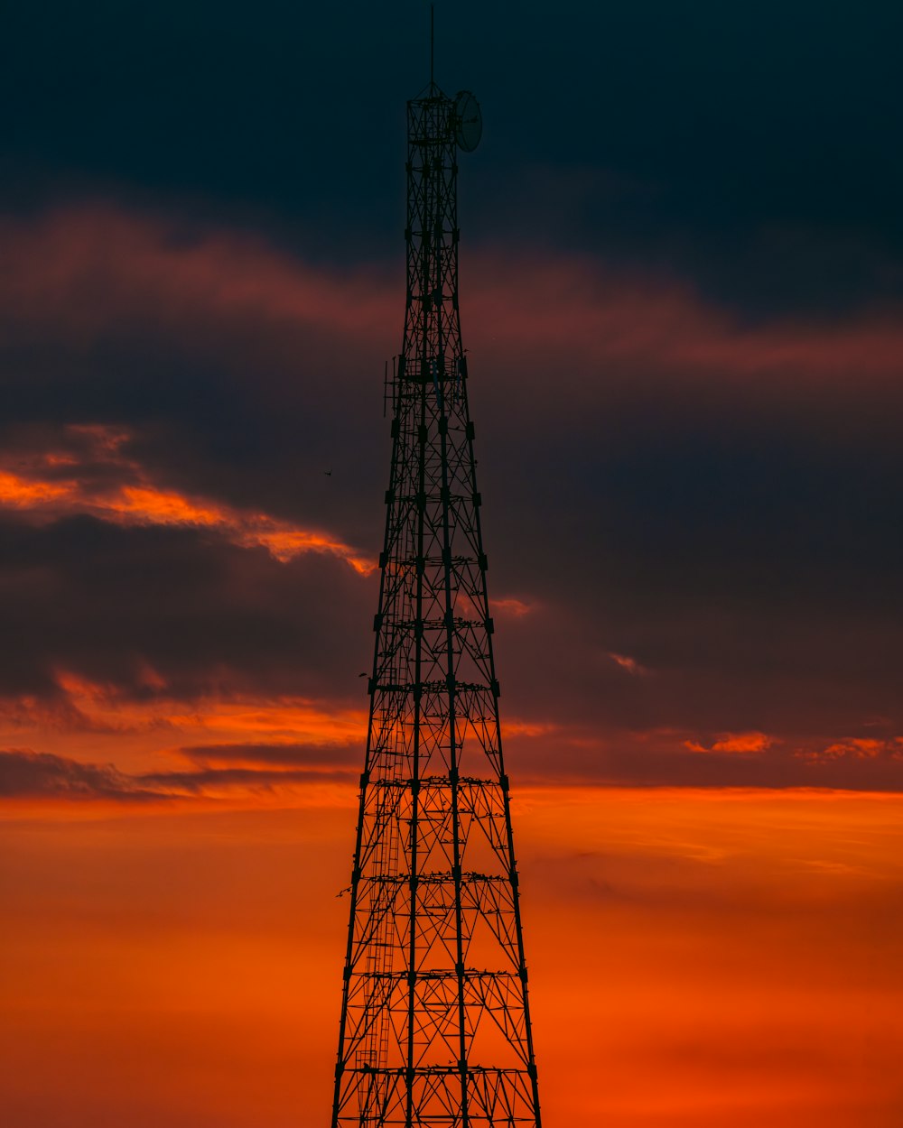 a very tall tower sitting in the middle of a field