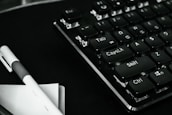 Close-up of a notebook keyboard with a rental agreement document beside it.