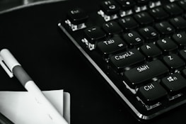 Close-up of a notebook keyboard with a rental agreement document beside it.