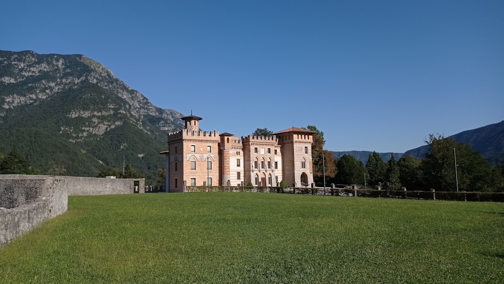 a large building sitting on top of a lush green field