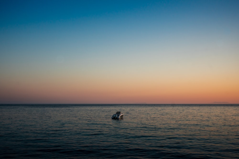 a boat floating on top of a large body of water