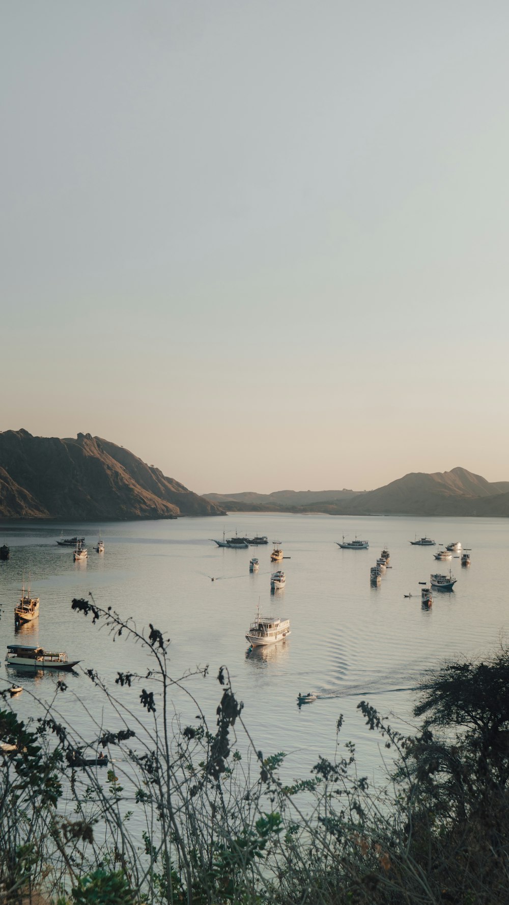 a group of boats floating on top of a lake