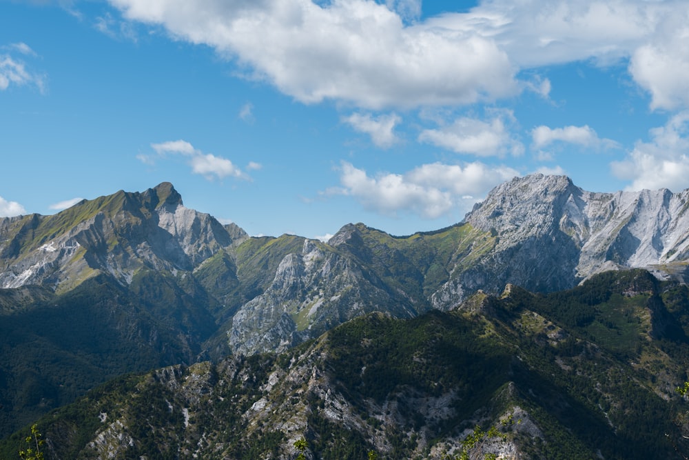 a view of a mountain range from the top of a hill