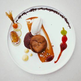 Elegant presentation of a fusion dessert featuring tropical fruits and delicate sauces.
