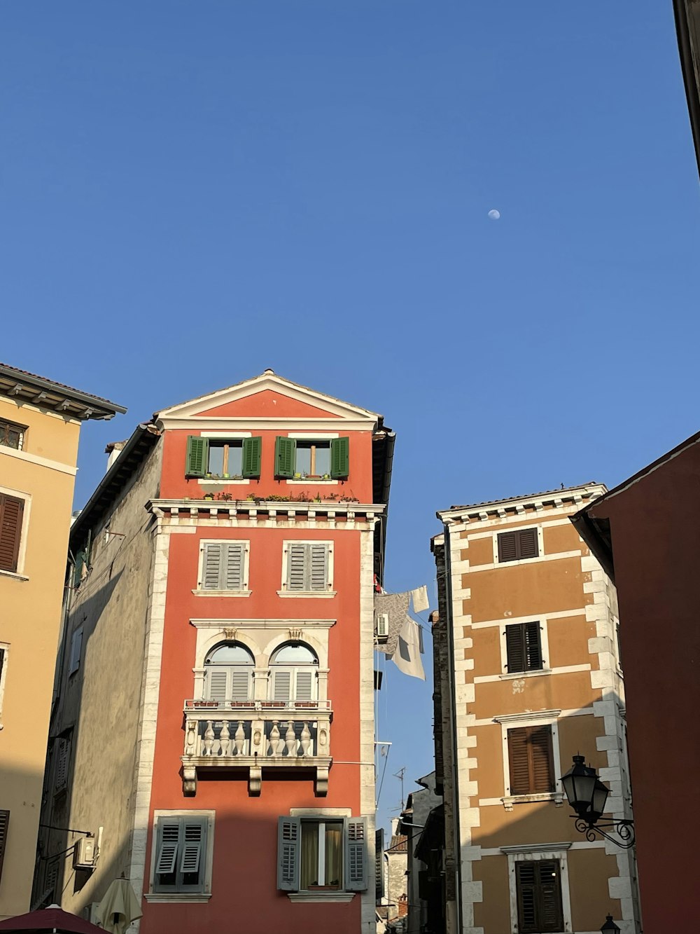 a red building with a balcony and balconies