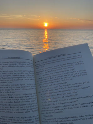 Cover of a Sunup Media book featuring a vibrant sunrise over a calm sea.