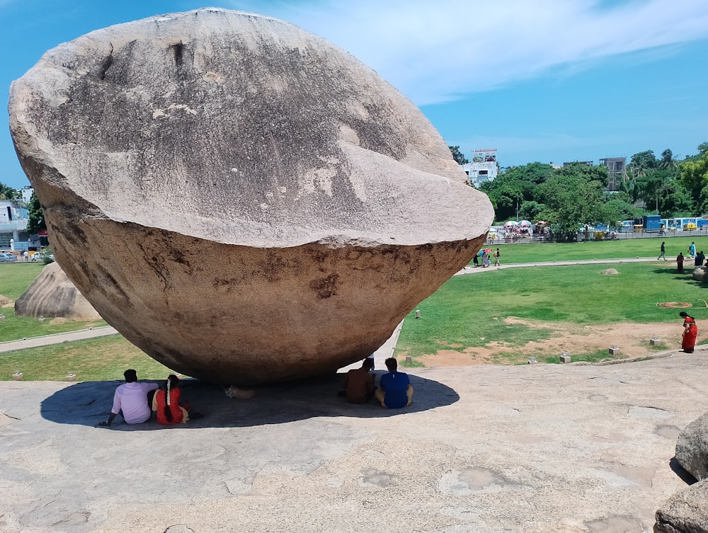 a large rock sitting on top of a cement slab