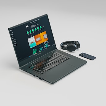 a laptop computer sitting on top of a white table