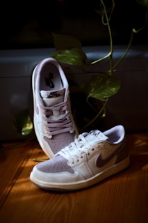A stylish pair of Nike running shoes displayed on a wooden surface.