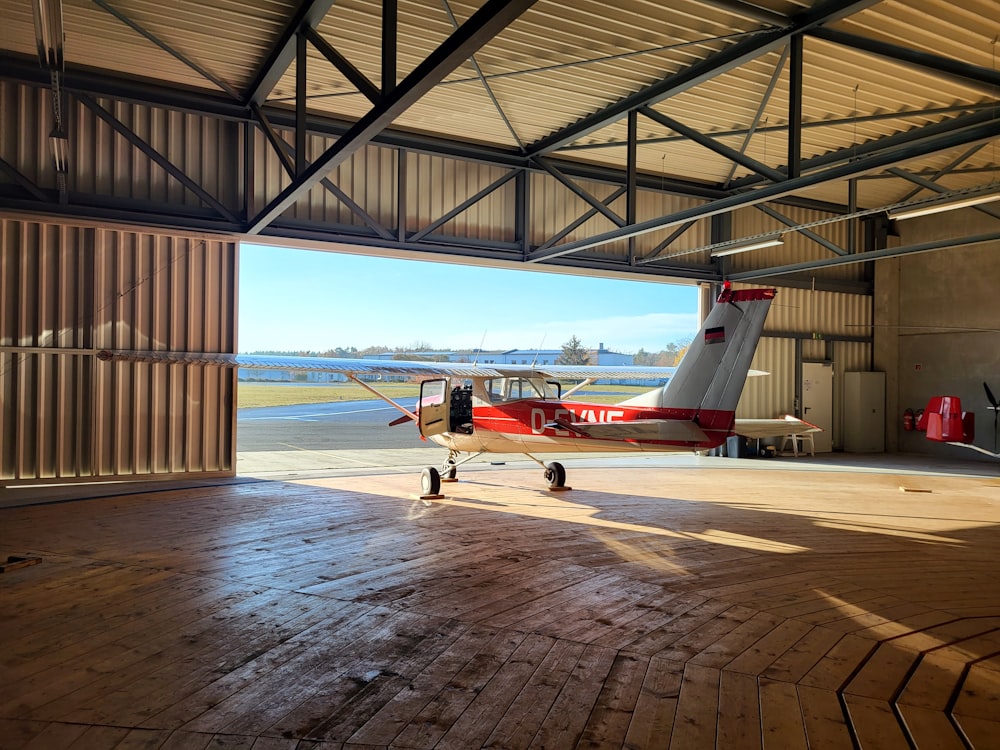 a small plane is parked in a hangar