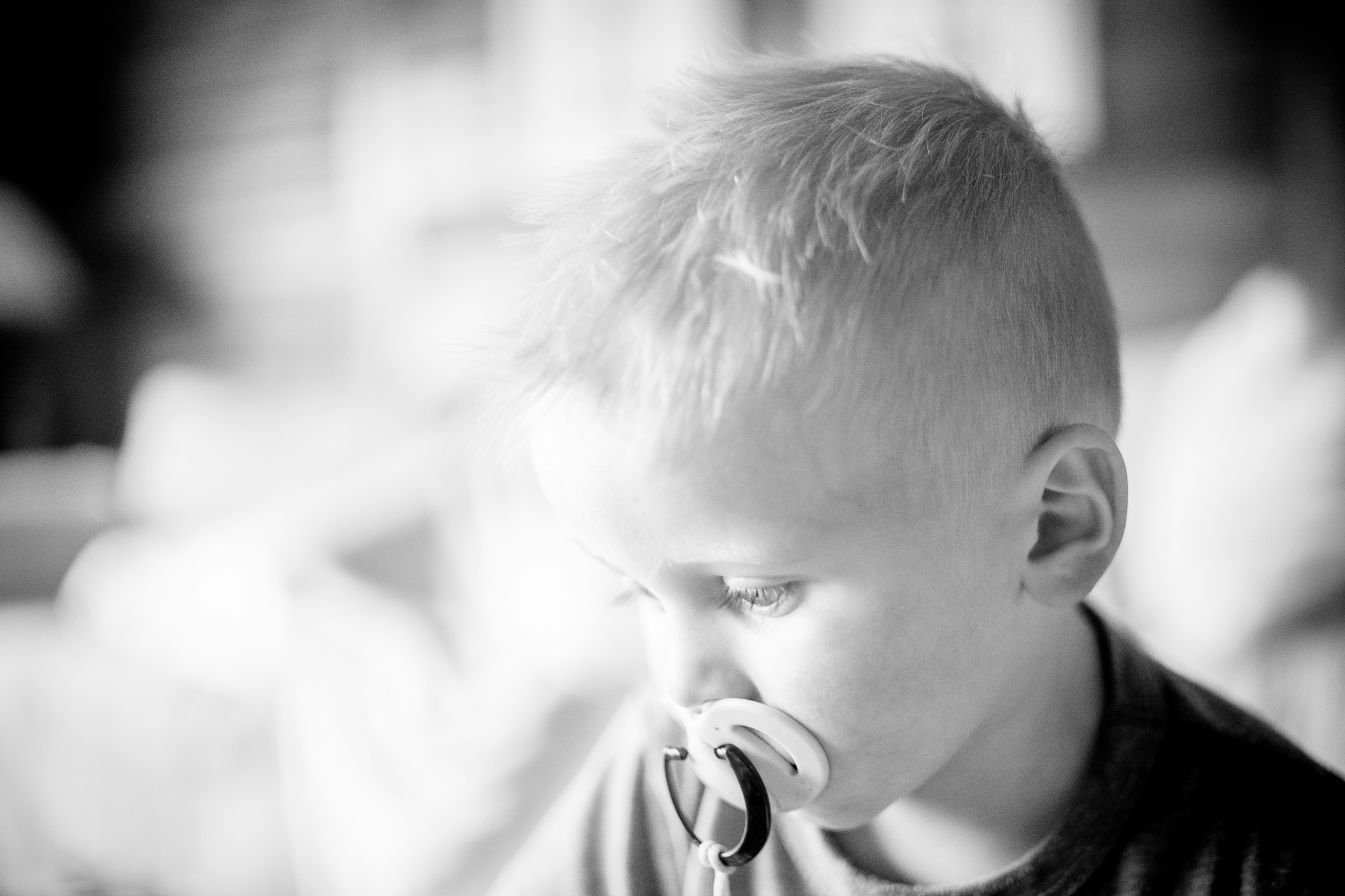A young boy with a pacifier in his mouth photo Free South africa