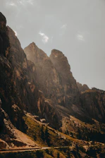 A winding mountain trail bathed in golden sunlight during early morning.