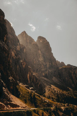 A winding mountain trail bathed in golden sunlight during early morning.
