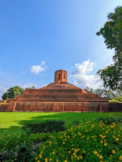 a large brick structure with a clock tower on top of it